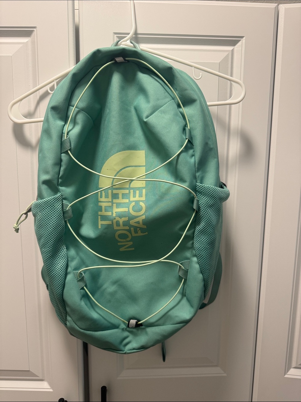 The North Face Mint Green Backpack with Pale Yellow Logo